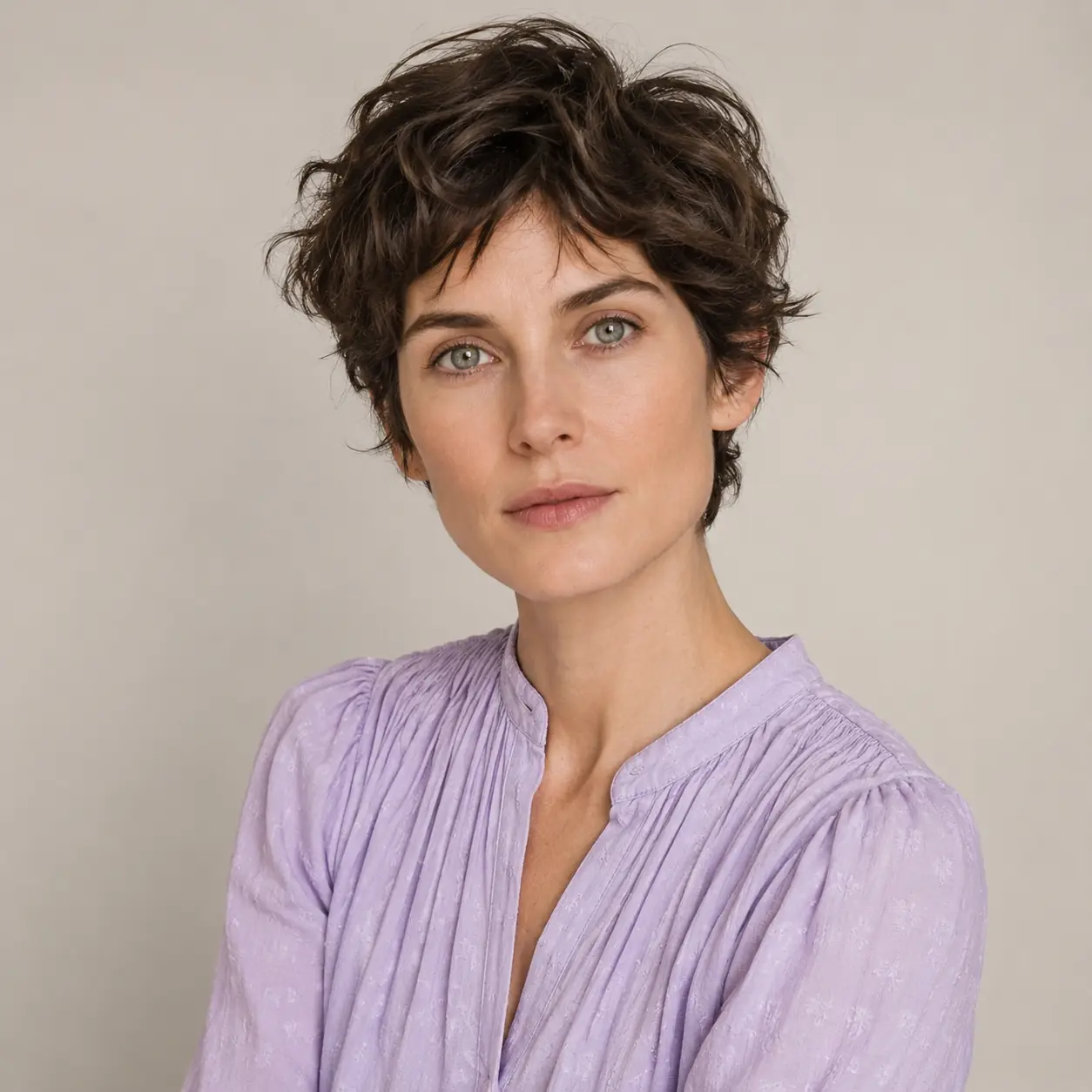 Short wavy pixie crop with natural bend left long on top for soft, androgynous texture