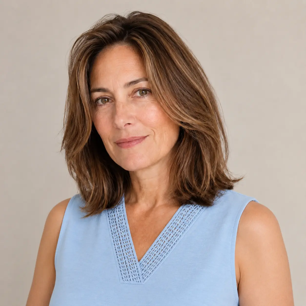 Caramel balayage layered lob with soft dimensional movement over 50