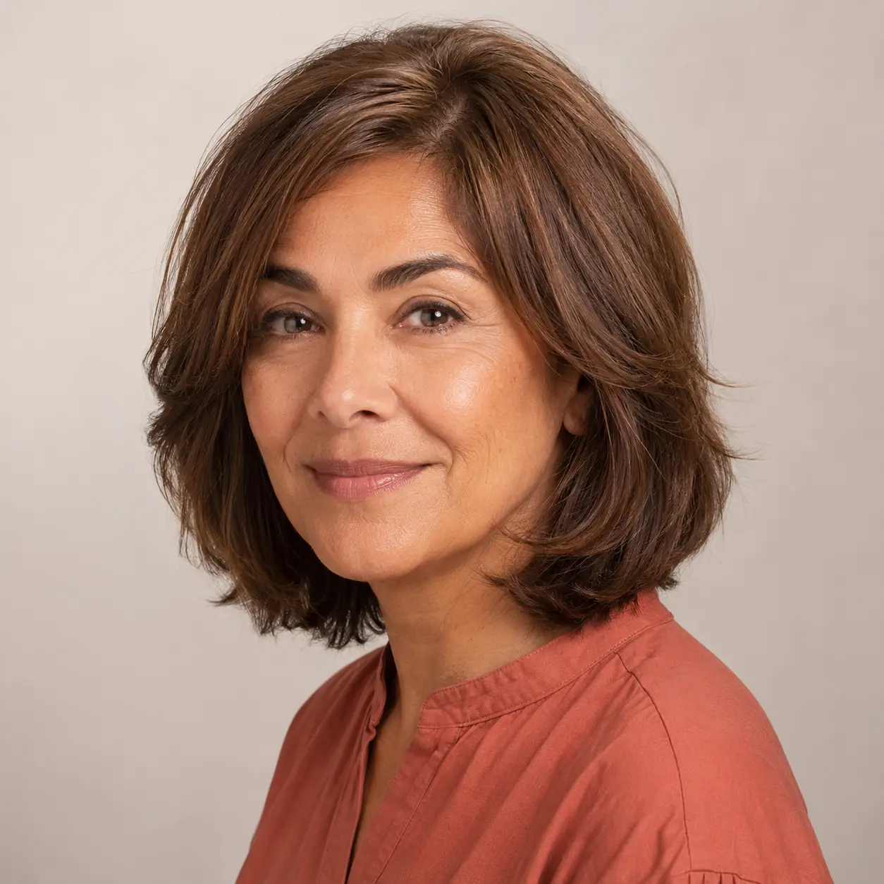 Warm auburn chin bob with a glossy finish, rich and modern on mature hair