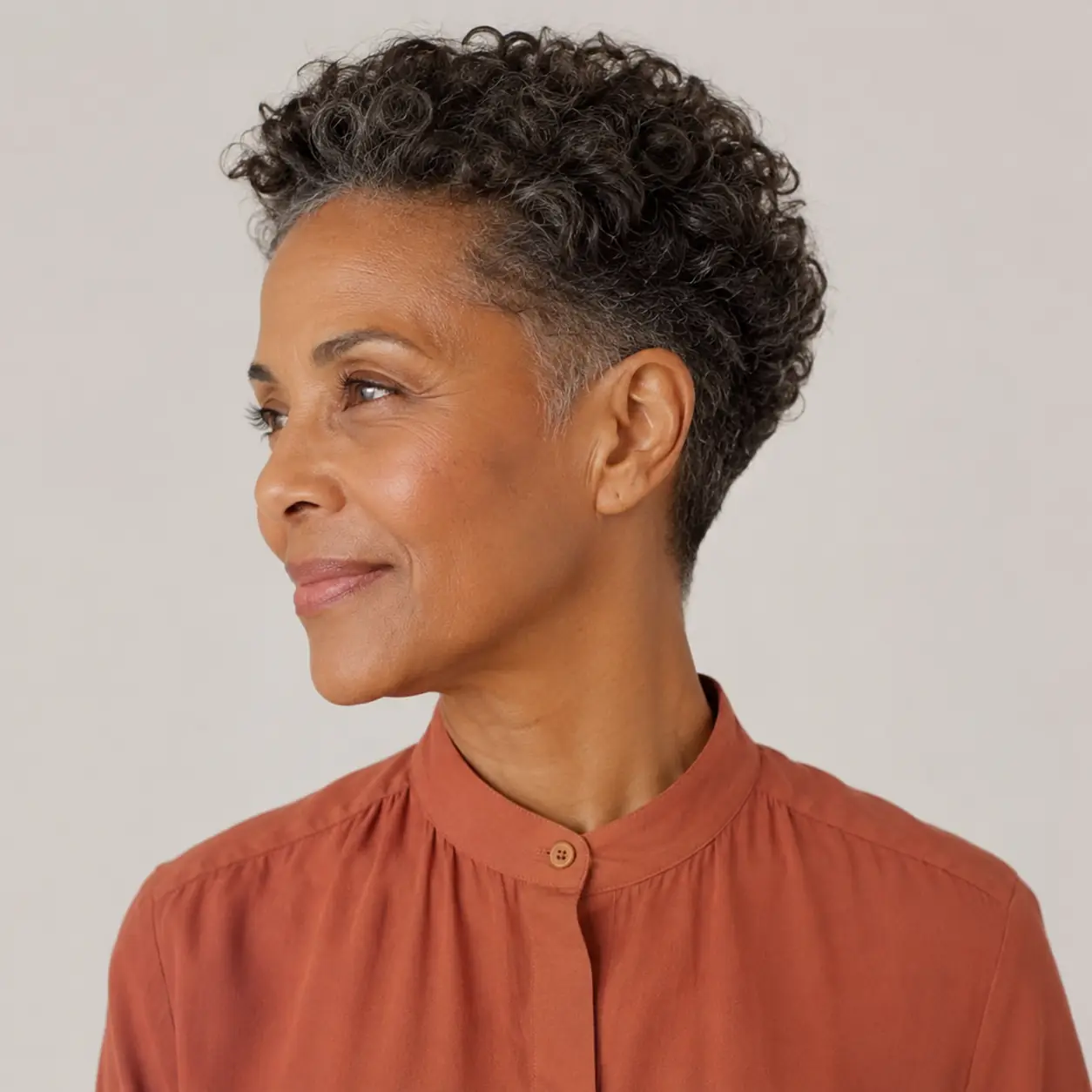 Silver curly pixie making the most of natural texture in a full modern shape