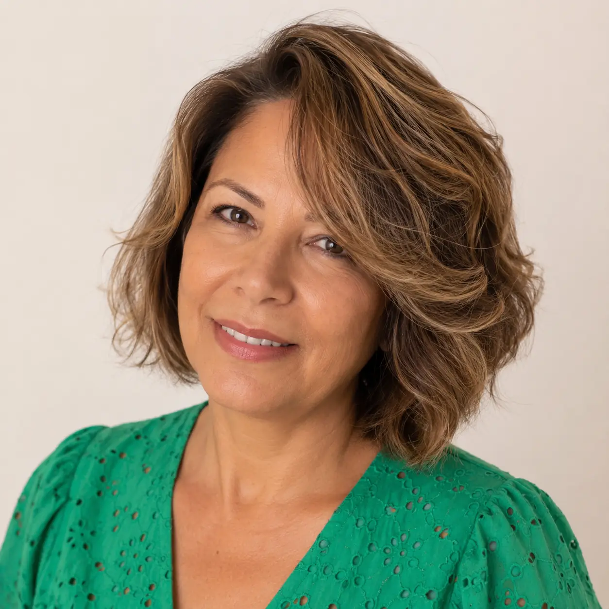 Warm auburn wavy bob with real volume, full and youthful over 50