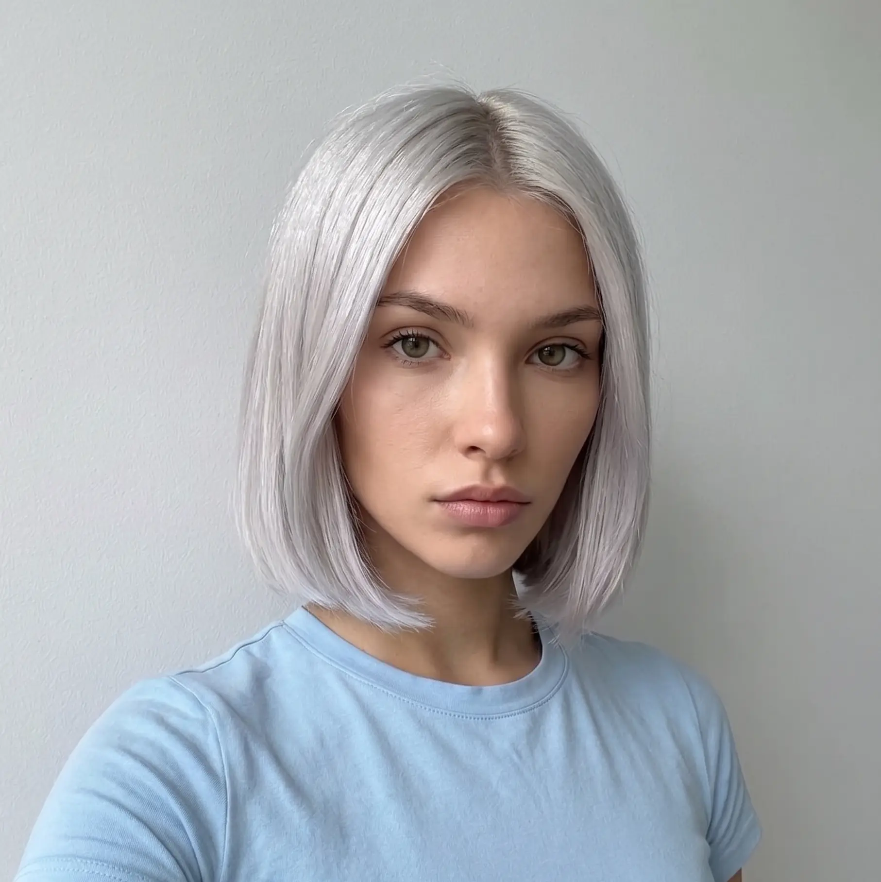 Polished silver bob with a soft side part and a smooth sleek finish on straight hair