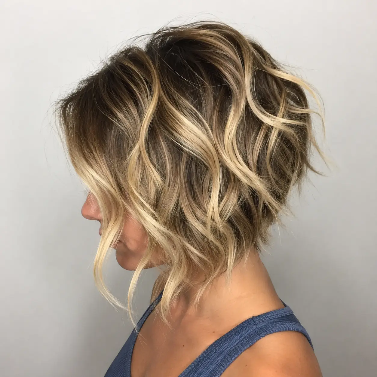 A-line layered bob haircut angled longer at the front and shorter at the back with messy interior layers