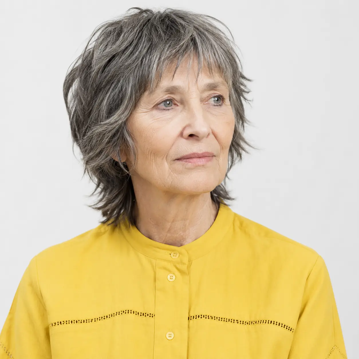 A shaggy silver pixie with piecey, spiky texture closes the gallery on an easy, modern note on a woman over 70