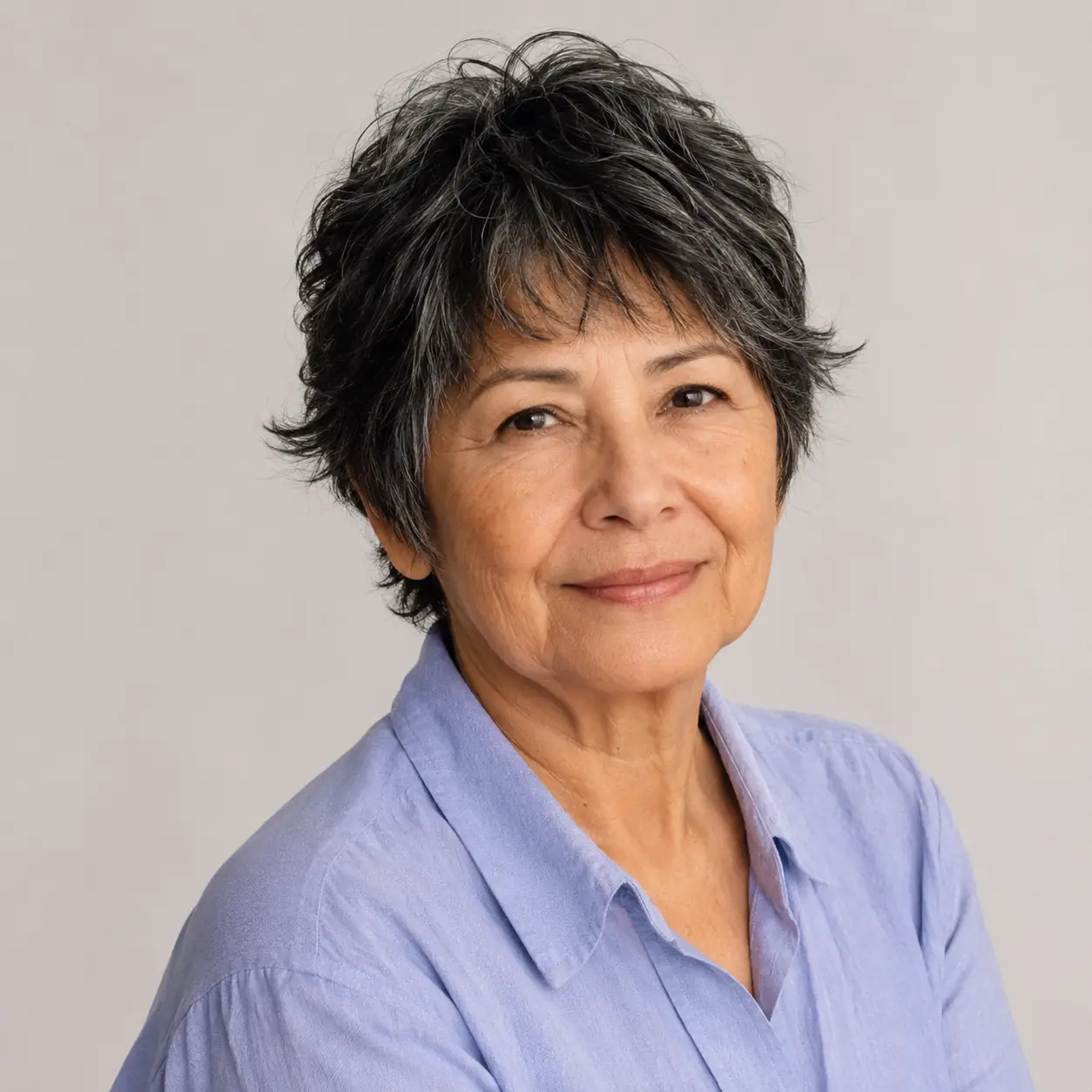A textured crop with piecey layers keeps this cut full of movement and touchable texture on a woman over 70
